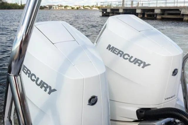 Slide: The Image of 2024 Axopar 37 Sun Top with twin Mercury outboard engines on water. - 27