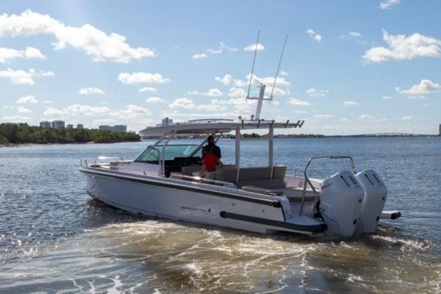 Slide: The Image of 2024 Axopar 37 Sun Top boat cruising on a sunny day. - 3