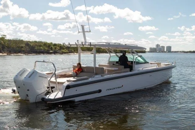 Slide: The Image of 2024 Axopar 37 Sun Top boat cruising on a sunny day. - 4