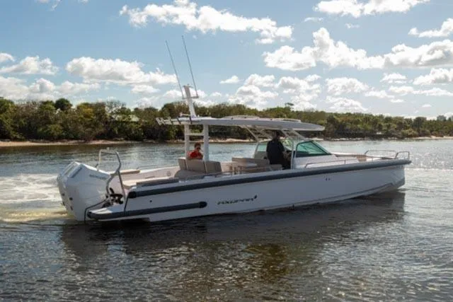 Slide: The Image of 2024 Axopar 37 Sun Top boat cruising on a sunny day. - 6