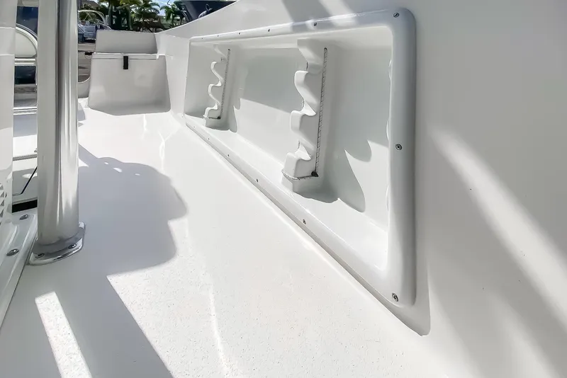 Slide: The Image of 2024 KenCraft 21 boat interior with rod holders and clean white finish. - 11