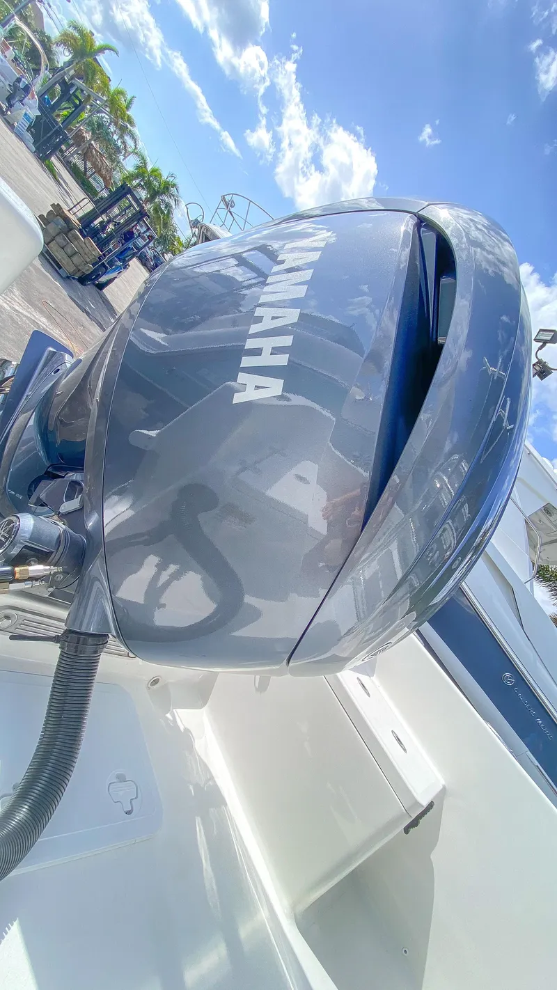 Slide: The Image of 2024 KenCraft 21 boat with Yamaha outboard motor under clear blue sky. - 19