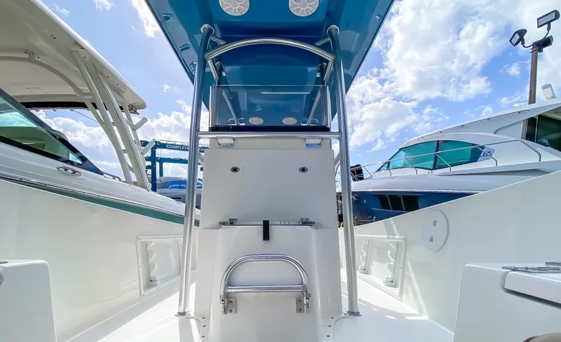 Slide: The Image of 2024 KenCraft 21 boat center console with blue T-top and stainless steel railing. - 8