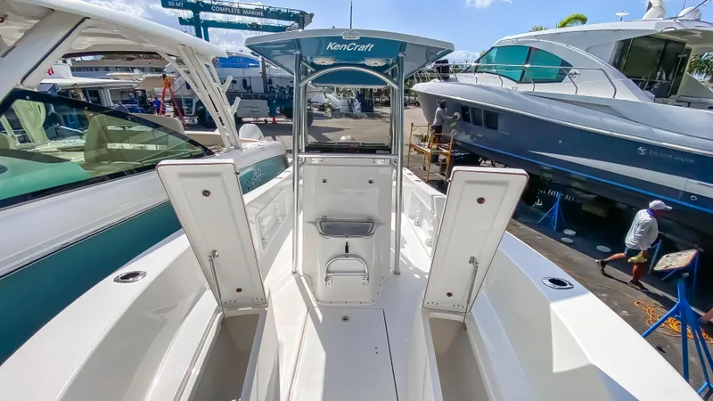 Slide: The Image of 2024 KenCraft 21 boat with open storage compartments at a marina. - 9
