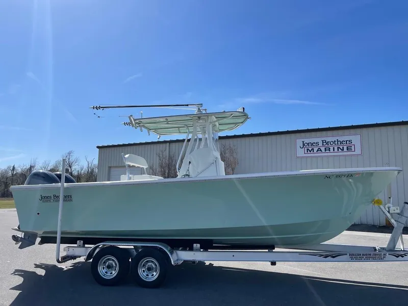 Slide: The Image of 2025 Jones Brothers 26 Cape Fisherman boat docked on a sunny day. - 2