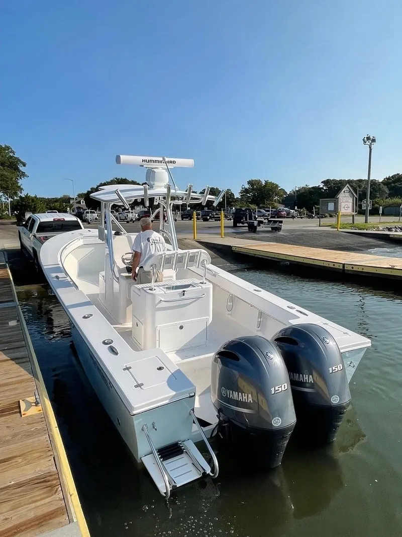 Slide: The Image of 2025 Jones Brothers 26 Cape Fisherman boat docked at a marina. - 6