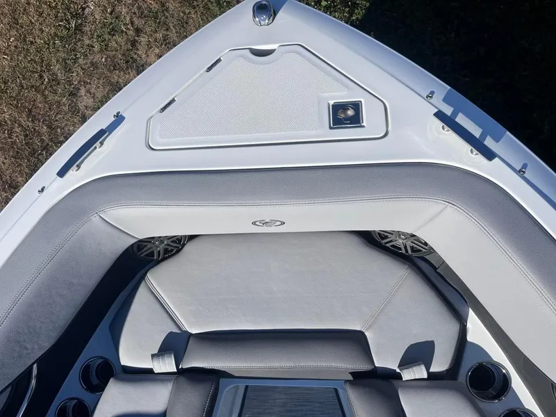 Slide: The Image of 2024 Cobalt CS23 boat interior with gray seating and storage compartment. - 16