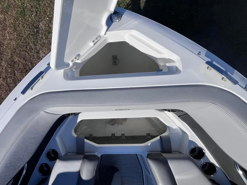 Slide: The Image of 2024 Cobalt CS23 boat interior with open storage compartment and seating area. - 17
