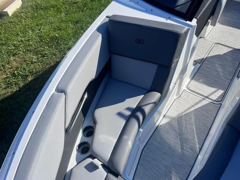 Slide: The Image of 2024 Cobalt CS23 boat interior with gray seating and cup holders. - 18