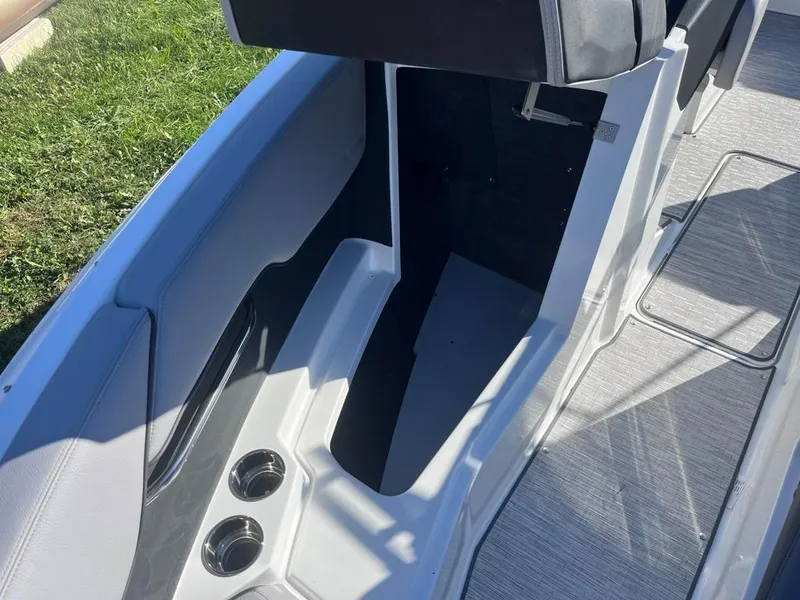Slide: The Image of 2024 Cobalt CS23 boat interior with cup holders and seating area. - 19