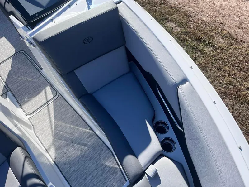 Slide: The Image of 2024 Cobalt CS23 boat interior with gray seating and cup holders. - 20