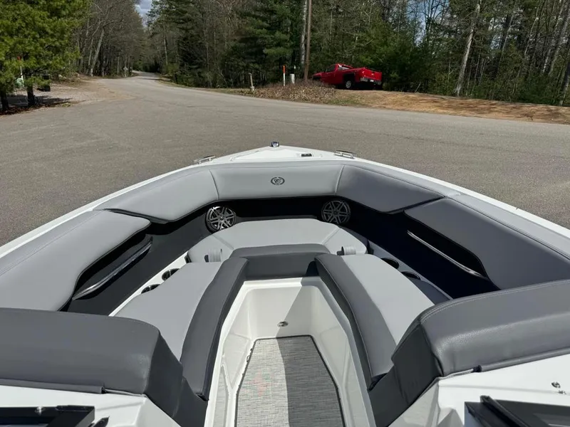 Slide: The Image of 2024 Cobalt CS23 boat interior with gray seating and speakers. - 22