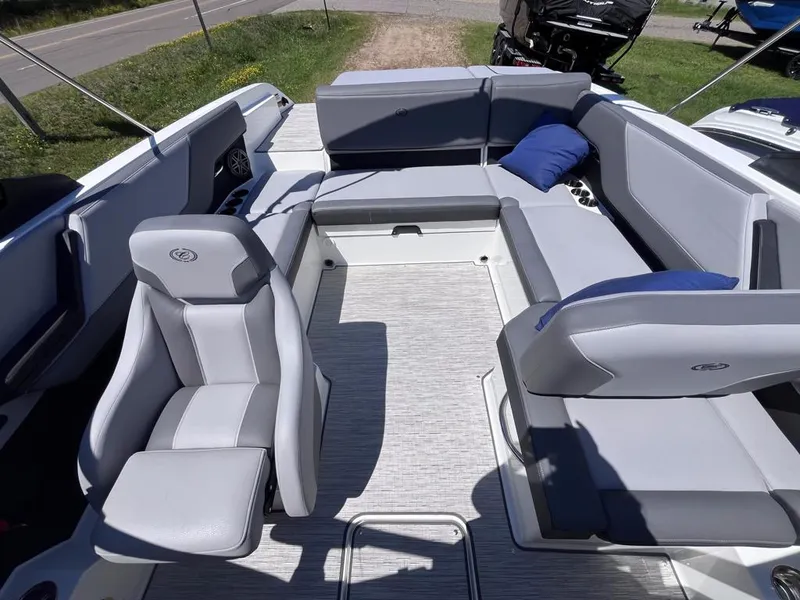 Slide: The Image of 2024 Cobalt CS23 boat interior with gray seating and blue cushion. - 24