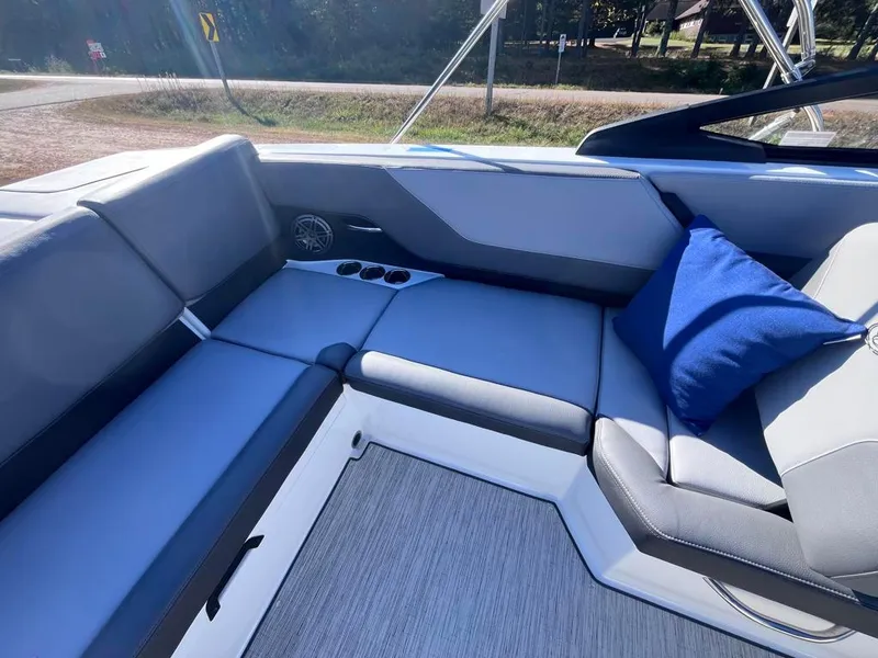 Slide: The Image of 2024 Cobalt CS23 boat interior with gray seating and blue cushion. - 29
