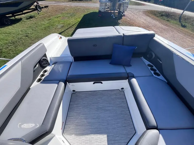 Slide: The Image of 2024 Cobalt CS23 boat interior with gray seating and blue cushion. - 30