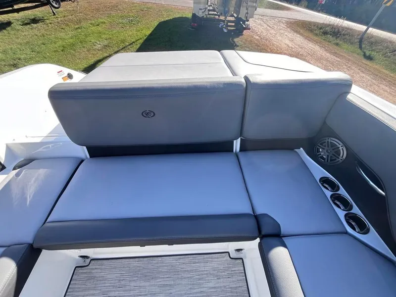 Slide: The Image of 2024 Cobalt CS23 boat interior with gray seating and cup holders. - 31