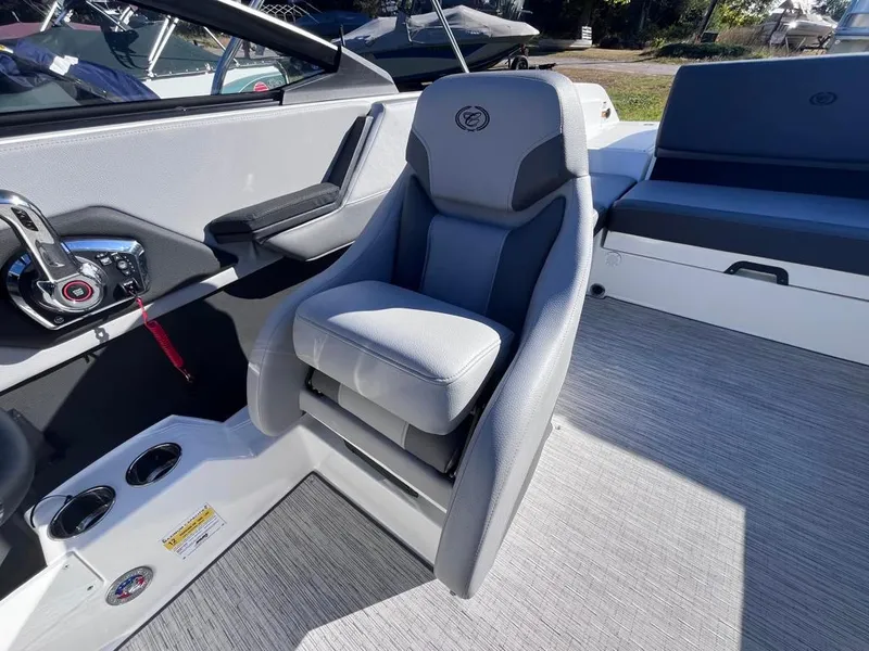 Slide: The Image of 2024 Cobalt CS23 boat interior with gray captain's seat and modern controls. - 38