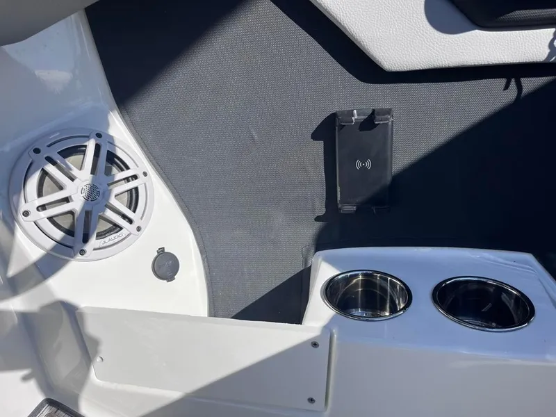 Slide: The Image of 2024 Cobalt CS23 boat interior with speaker, phone holder, and cup holders. - 40