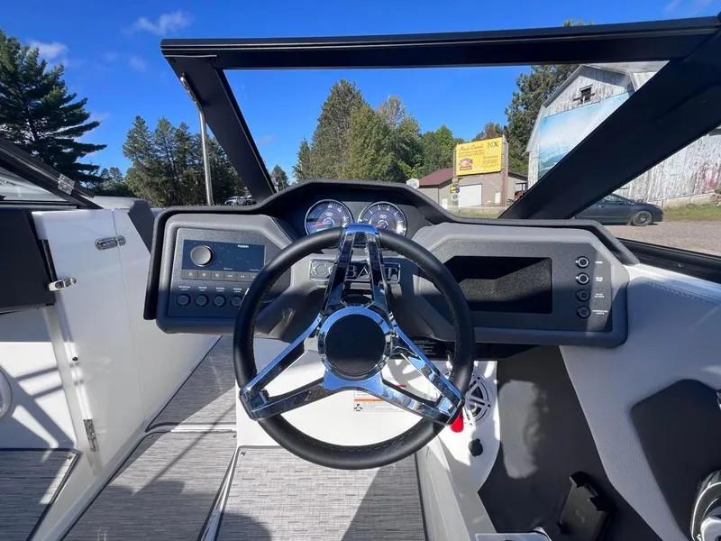 Slide: The Image of 2024 Cobalt CS23 boat dashboard with steering wheel and control panel. - 41