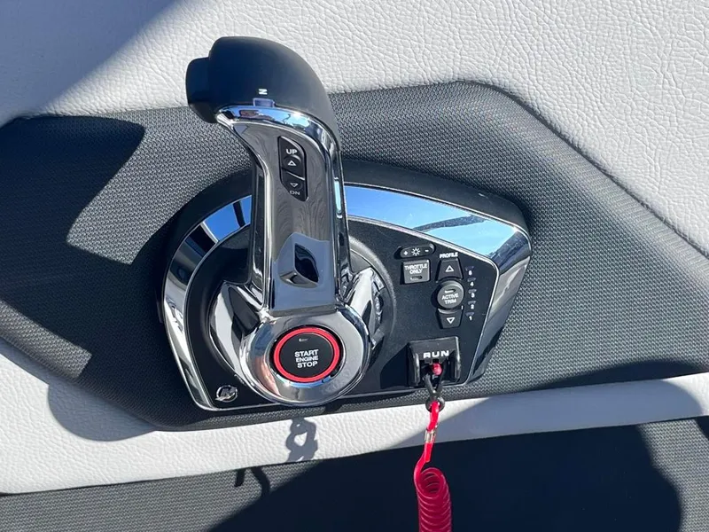 Slide: The Image of 2024 Cobalt CS23 boat throttle control with start/stop button and safety lanyard. - 45