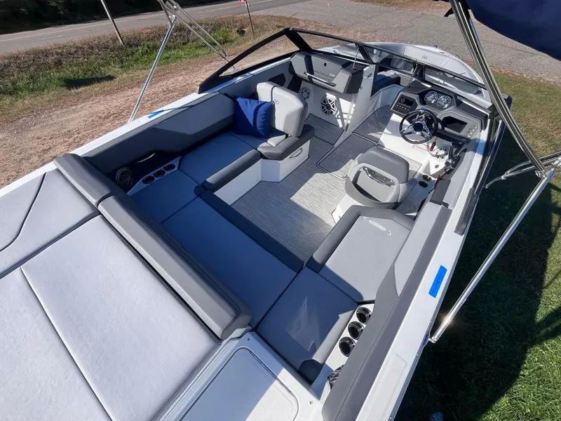 Slide: The Image of 2024 Cobalt CS23 boat interior with spacious seating and modern dashboard design. - 46