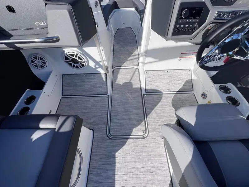 Slide: The Image of 2024 Cobalt CS23 boat interior with modern seating and sleek dashboard design. - 60