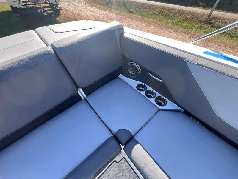 Slide: The Image of 2024 Cobalt CS23 boat interior with gray seating and cup holders. - 70