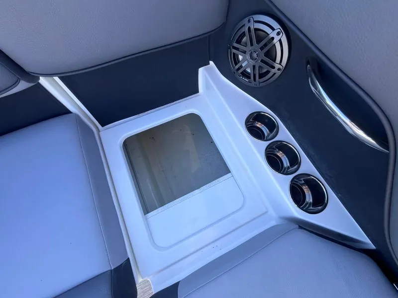 Slide: The Image of 2024 Cobalt CS23 boat interior with cup holders and speaker. - 71