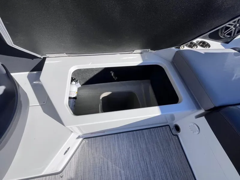 Slide: The Image of 2024 Cobalt CS23 boat storage compartment with sleek interior design. - 74