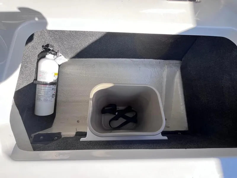 Slide: The Image of 2024 Cobalt CS23 storage compartment with fire extinguisher and container. - 75