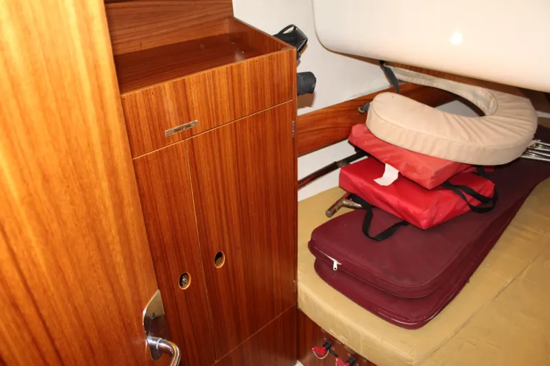 Slide: The Image of Interior cabin of 2003 Dufour Gib Sea 37 sailboat with wooden storage and cushions. - 37