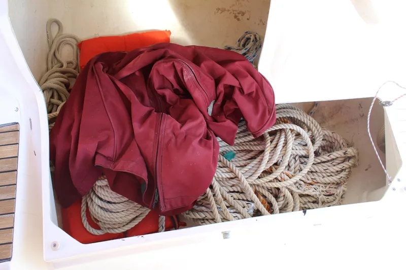 Slide: The Image of Storage compartment on a 2003 Dufour Gib Sea 37 with ropes and a red jacket. - 44