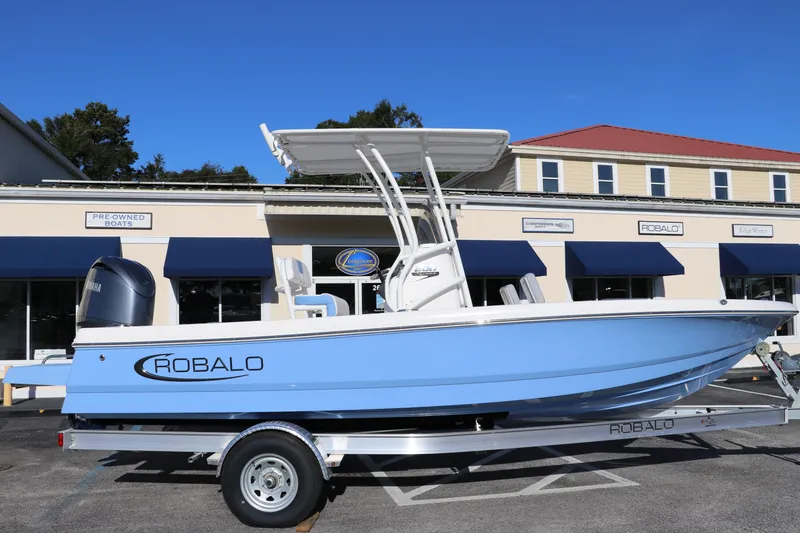 The Image of 2024 Robalo 206 Cayman boat on trailer, parked outside dealership. - 0