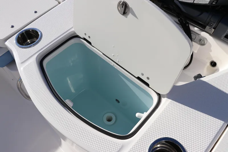 Slide: The Image of 2024 Robalo 206 Cayman boat livewell with open lid and cup holders. - 11