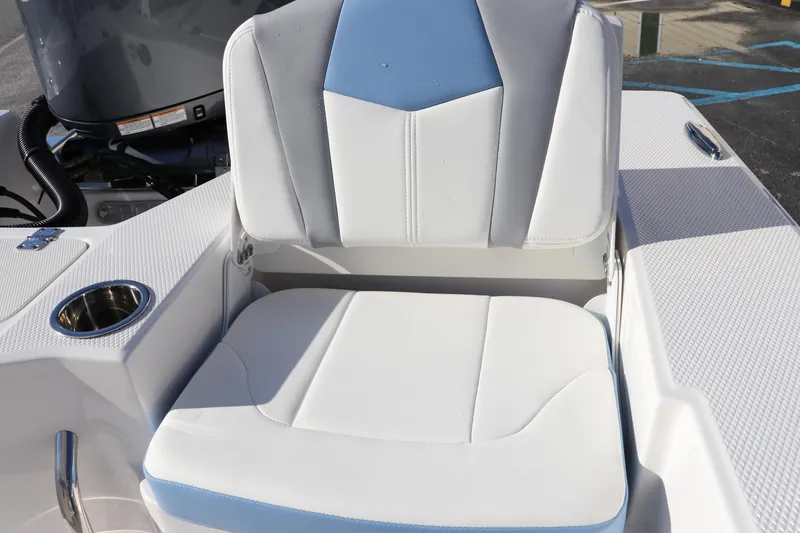 Slide: The Image of 2024 Robalo 206 Cayman boat seat with cup holder, white and blue upholstery. - 13