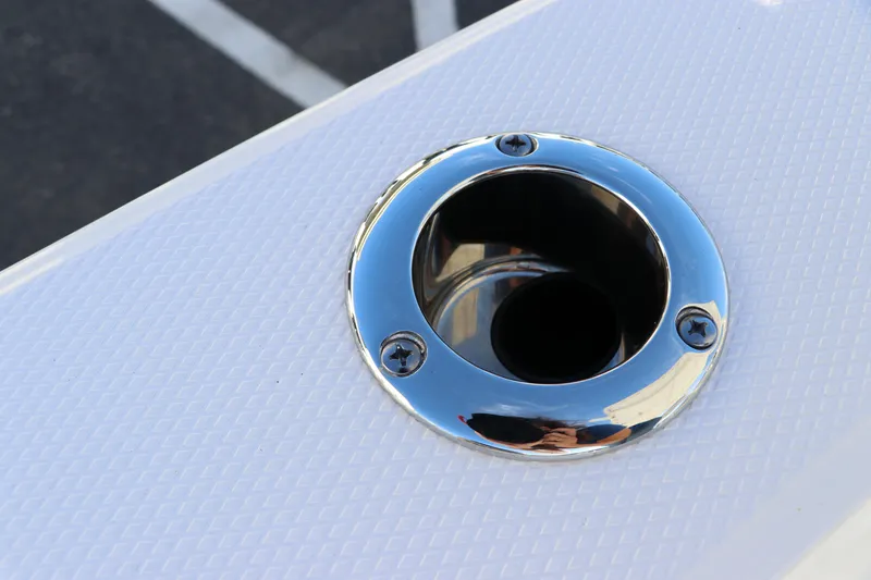 Slide: The Image of Close-up of 2024 Robalo 206 Cayman boat's chrome rod holder on textured surface. - 17