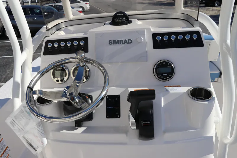 Slide: The Image of 2024 Robalo 206 Cayman boat dashboard with steering wheel and Simrad electronics. - 20