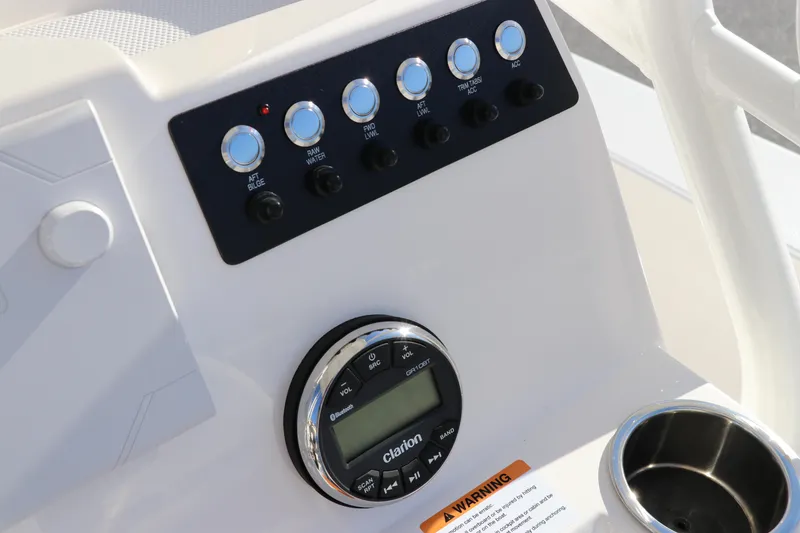 Slide: The Image of Control panel of 2024 Robalo 206 Cayman boat with switches and Clarion audio system. - 21