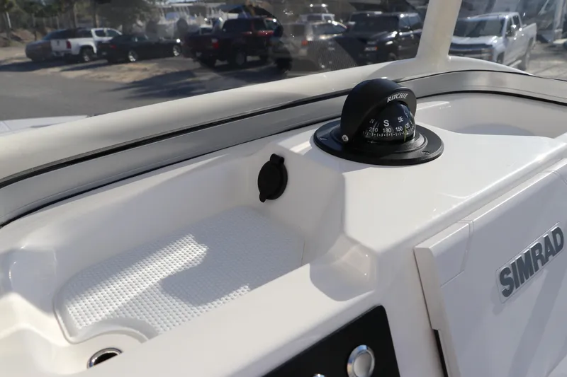 Slide: The Image of 2024 Robalo 206 Cayman boat dashboard with compass and Simrad electronics. - 25