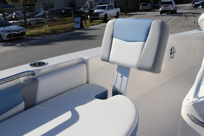 Slide: The Image of 2024 Robalo 206 Cayman boat interior with cushioned seating and cup holder. - 29