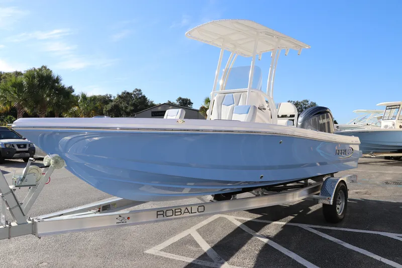 Slide: The Image of 2024 Robalo 206 Cayman boat on trailer, light blue hull, sunny day. - 3