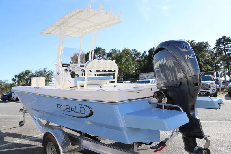 Slide: The Image of 2024 Robalo 206 Cayman boat with Yamaha 150 engine, parked outdoors. - 4