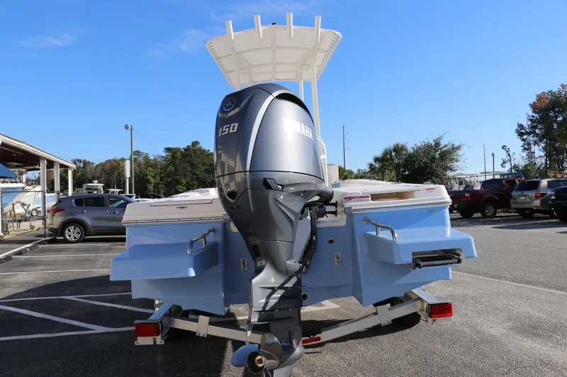 Slide: The Image of 2024 Robalo 206 Cayman boat with Yamaha 150 engine, parked outdoors. - 5