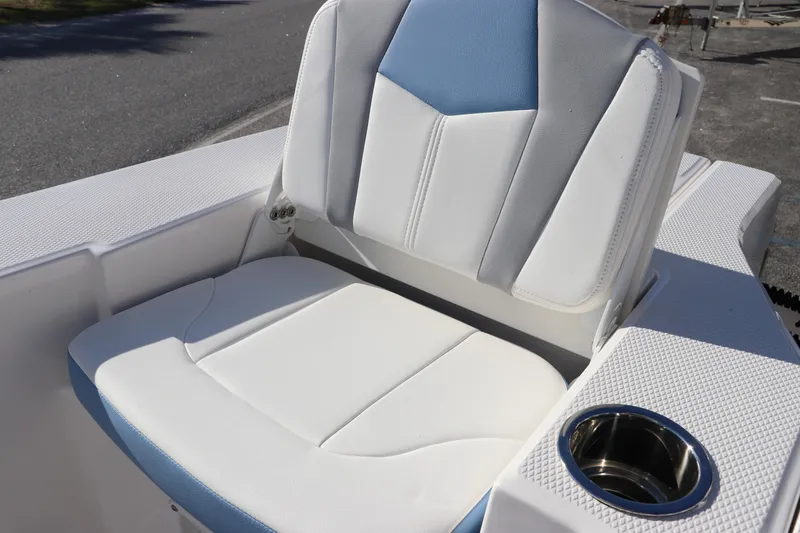 Slide: The Image of 2024 Robalo 206 Cayman boat seat with cup holder, featuring white and blue upholstery. - 9