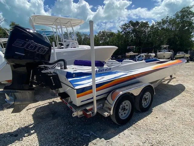 Slide: The Image of 2005 Liberator 21 boat with 300 horsepower engine on trailer. - 1
