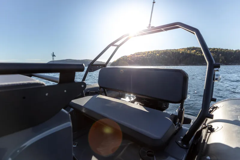 Slide: The Image of 2025 Zodiac Pro 5.5 boat interior with sunlit lake view. - 11