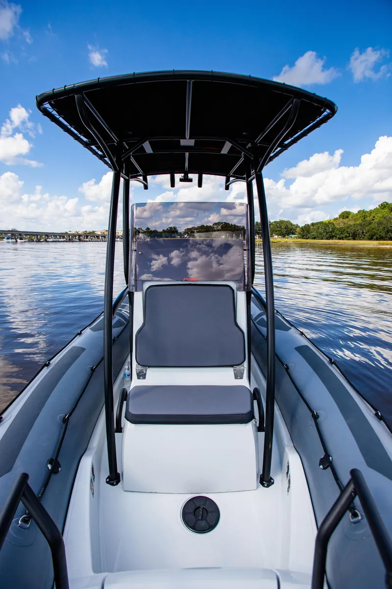 Slide: The Image of 2025 Zodiac Pro 5.5 boat on calm water under a clear blue sky. - 13