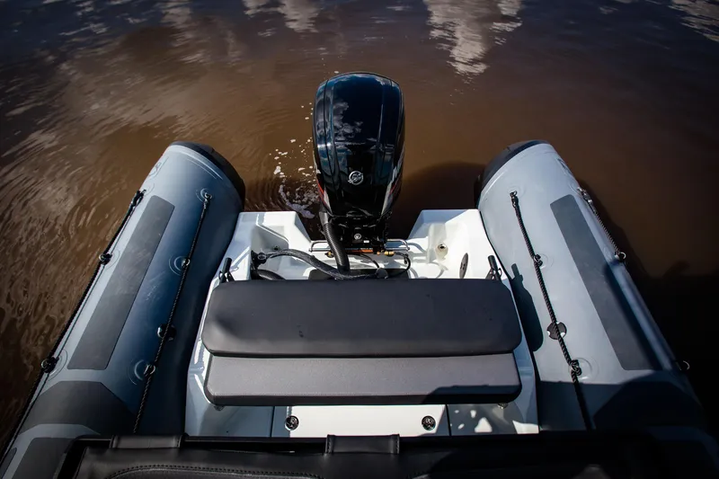 Slide: The Image of 2025 Zodiac Pro 5.5 inflatable boat with outboard motor on calm water. - 7