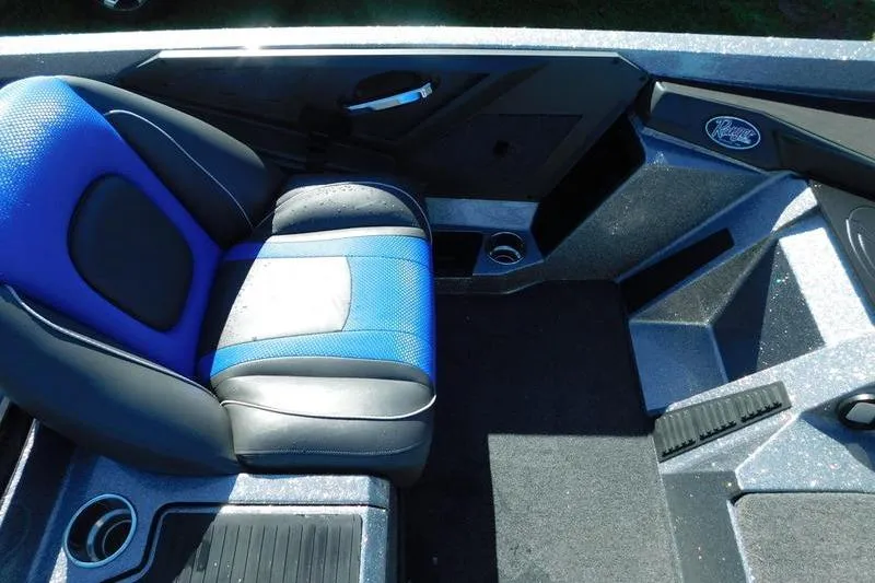Slide: The Image of 2024 Ranger Z518 boat interior with blue and black seating, cup holders, and sleek design. - 10