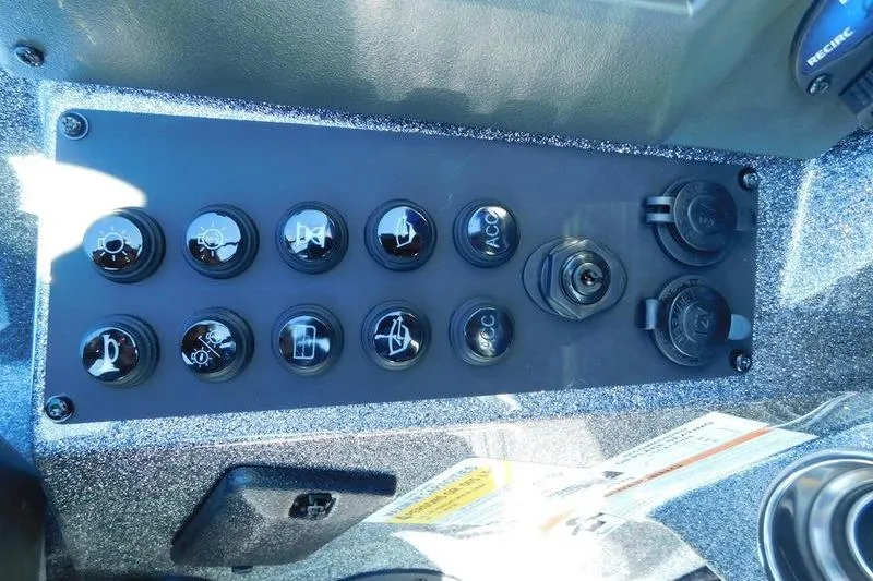 Slide: The Image of 2024 Ranger Z518 boat control panel with switches and power outlets. - 11